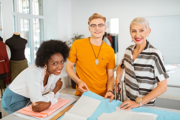 three team members with embroidery
